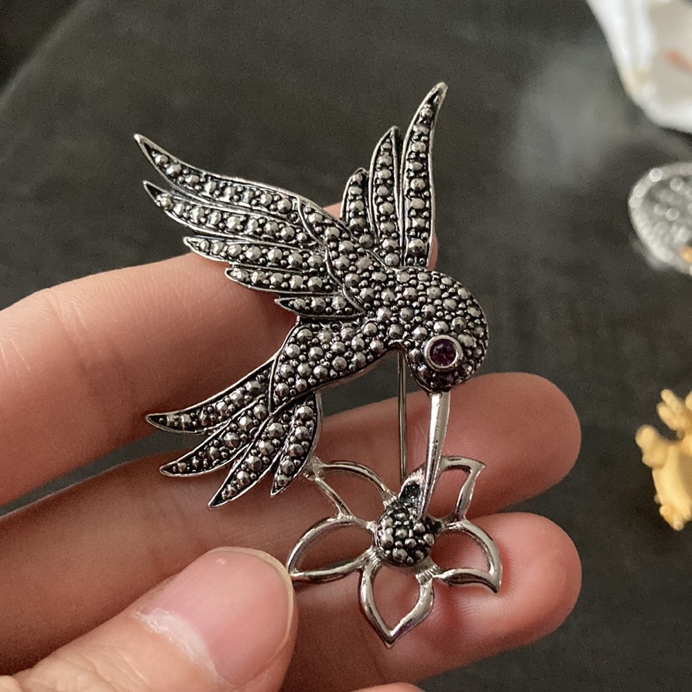Vintage Avon marcasite like metal bird with Ruby like eye brooch
